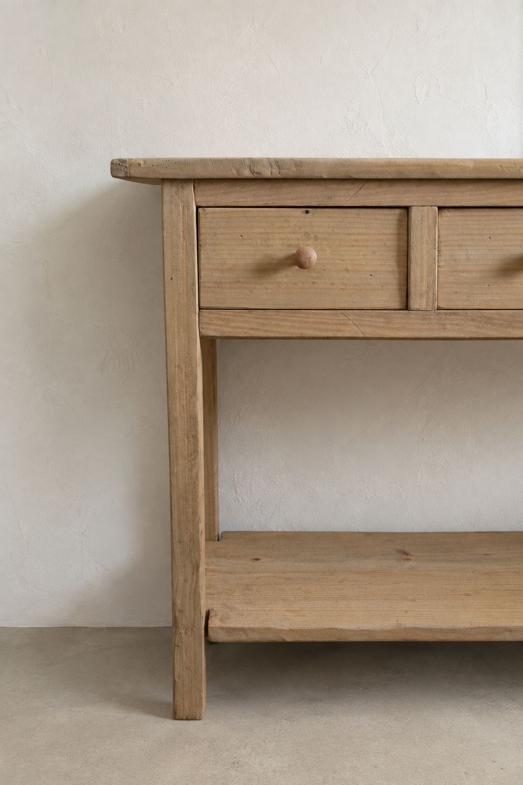 Close-up detail of the Mercantile console drawer, leg, and lower shelf in the Juniper & Bros. studio background