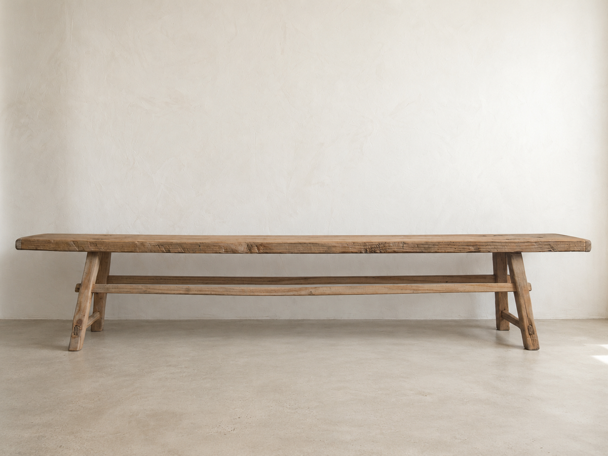 The Longhouse Bench, a nearly eight-foot solid pine bench with a natural, timeworn finish.