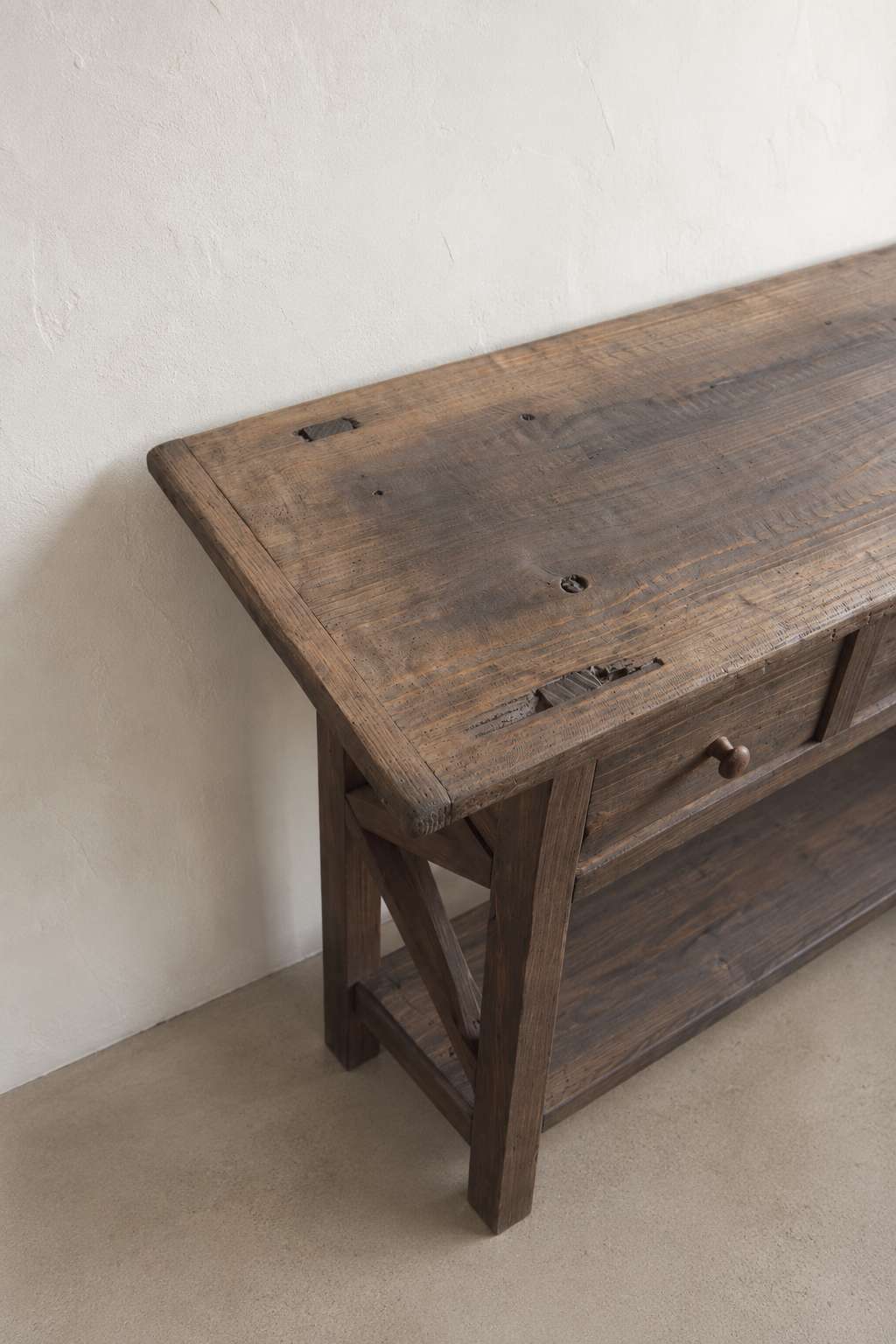 Close-up of the dark aged finish and natural wood character on The Hewn Console