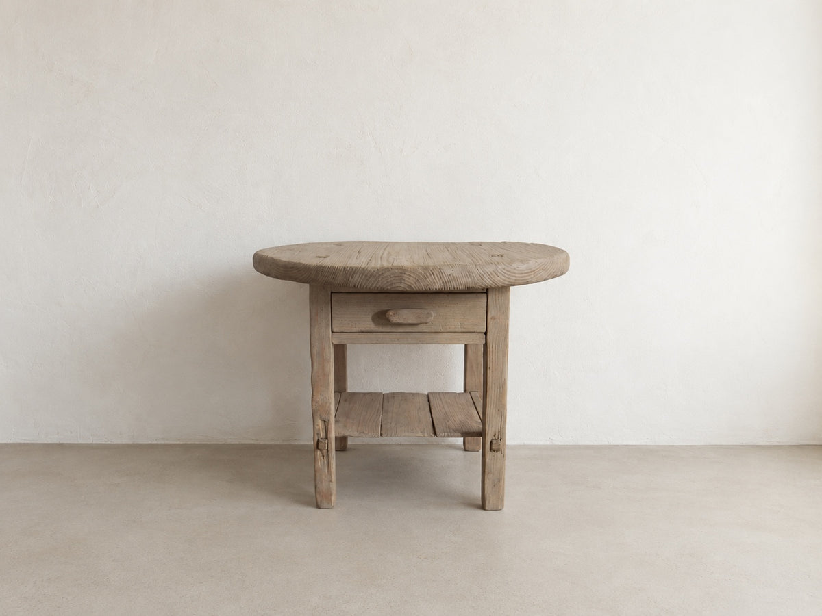     Front view of The Cooper Table, a handmade round accent table with drawer and lower shelf
