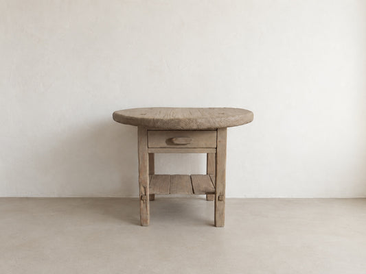     Front view of The Cooper Table, a handmade round accent table with drawer and lower shelf
