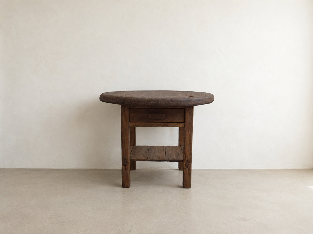     Front view of The Cooper Table, a handmade round accent table with drawer and lower shelf