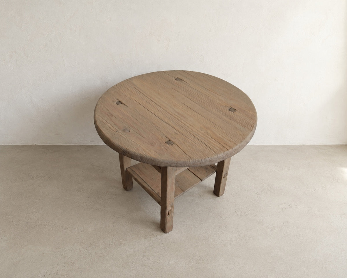     Elevated view of The Cooper Table showing the round solid wood top, natural grain, knots, and aged character