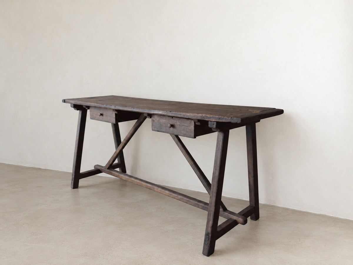 Angled view of The Trestle Console showing two drawers, trestle legs, and diagonal braces