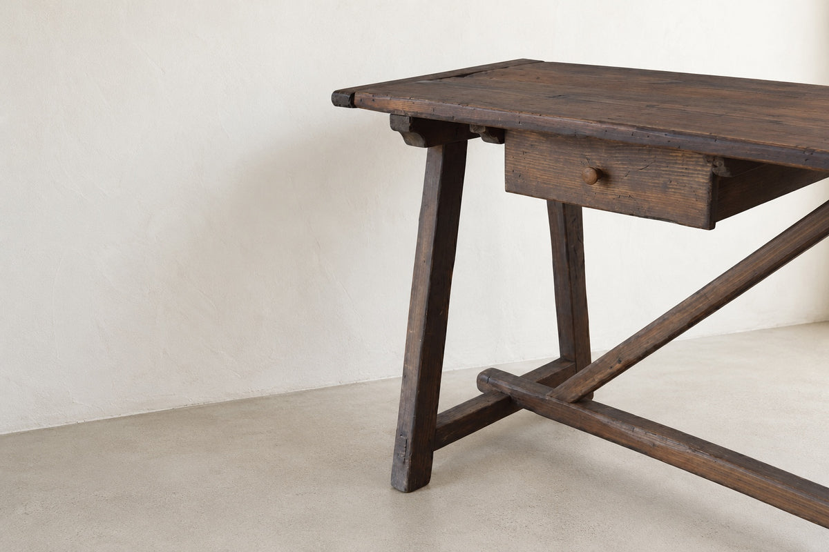 Hand-aged wood finish, drawer, and trestle brace detail on The Trestle Console
